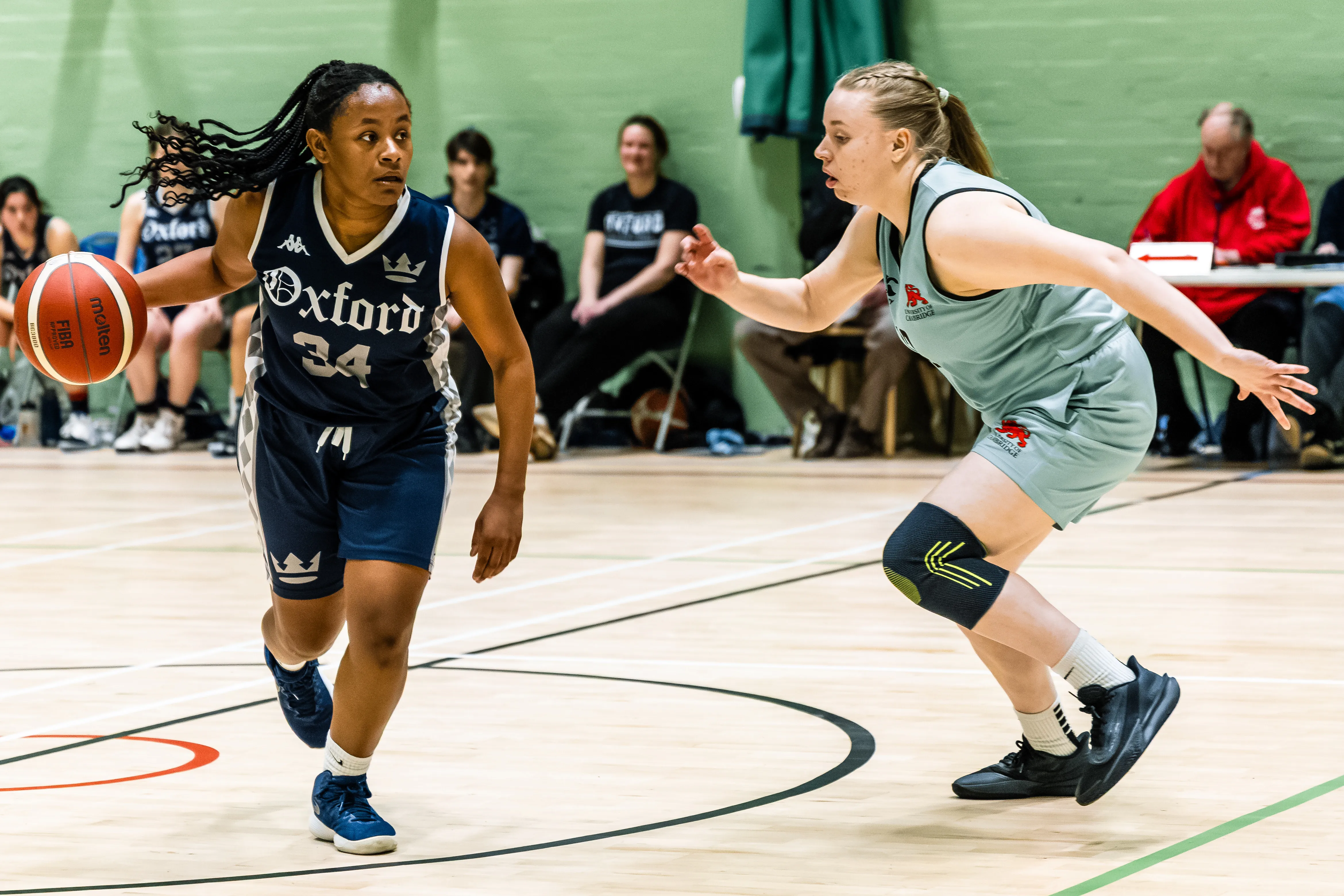 OUBbC player driving past a Cambridge defender